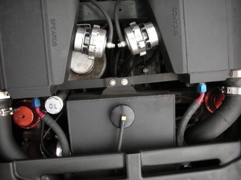 1998 Ford Crown Victoria - Engine bay showing twin black Spearco intercooler boxes, polished clamps, an oil filler, and red and blue AN fittings.