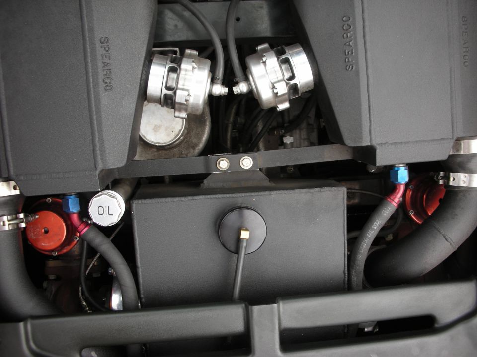 Engine bay with two black Spearco airboxes, an oil filler cap, and AN fittings