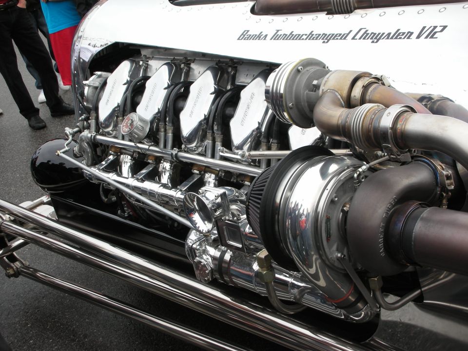 Side view of a chrome Banks Turbocharged Chrysler V12 with turbo and exhaust