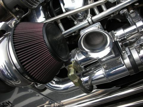 1998 Ford Crown Victoria - heavily chromed engine featuring a red K&N-style cone air filter and polished intake and pulleys.