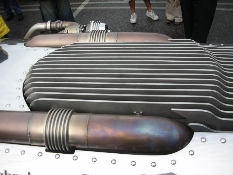 Close-up of a finned metal intercooler or heat exchanger on a vehicle