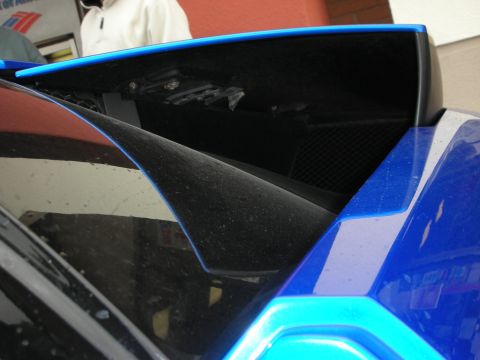 1998 Ford Crown Victoria - Detail of the blue Lamborghini's black rear air-intake scoop with dark mesh grille.