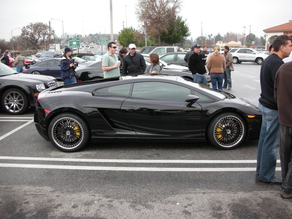 Black Lamborghini Gallardo side profile at a car meet