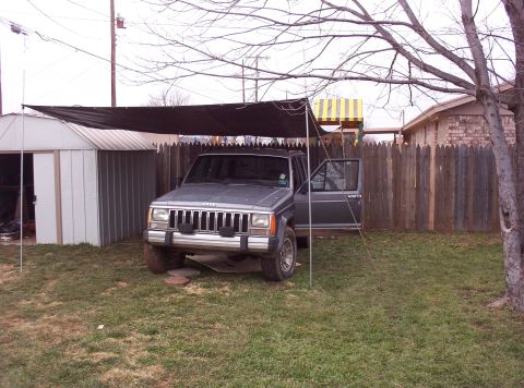 1987 Jeep Cherokee - This 1987 Jeep Cherokee is parked in a yard under a makeshift shelter.
