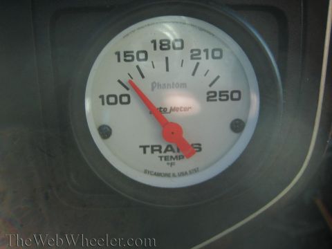 1990 Ford Bronco - Auto Meter Phantom transmission temperature gauge marked 100 to 250 degrees with the red needle near 130.