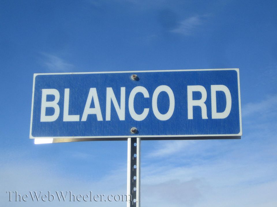 Blue 'Blanco Rd' street sign against a clear blue sky
