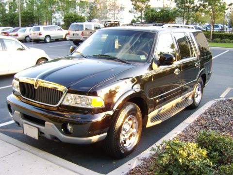 1996 Mercury Grand Marquis - A black Lincoln Navigator full-size SUV parked in a paved parking lot, viewed from the front-left three-quarter angle, showing its chrome w…
