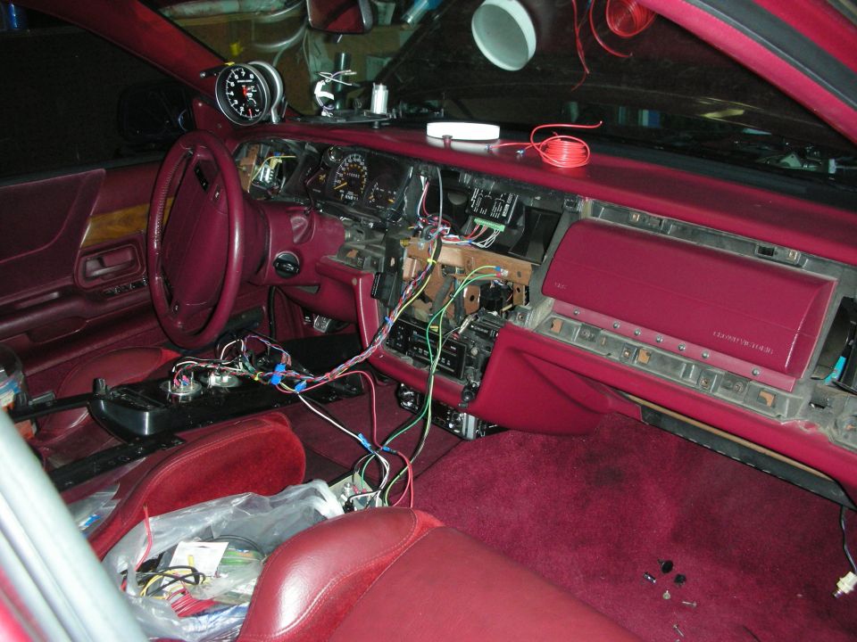 Interior of a 1992 Ford Crown Victoria with dashboard removed and wires exposed