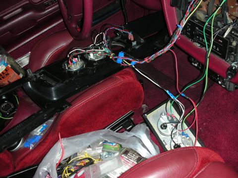 1992 Ford Crown Victoria - The interior of a car shows exposed wiring and gauges, indicating ongoing electrical work.