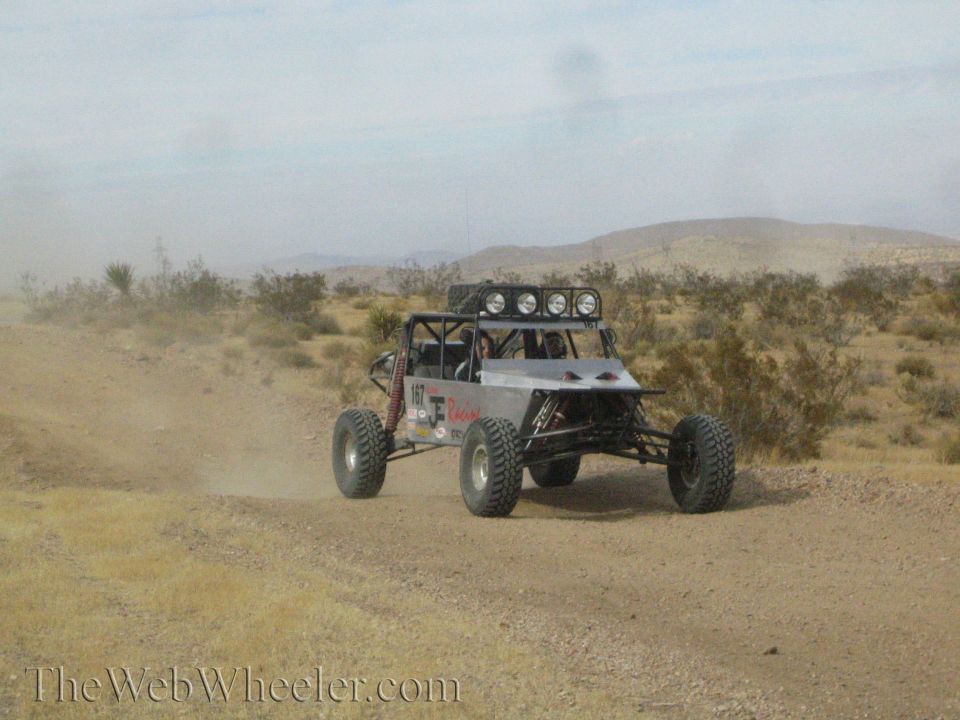 Off-road tube-frame race buggy with light bar on a desert trail