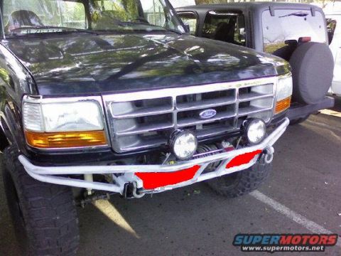1993 Ford Bronco - This 1993 Ford Bronco features a custom front bumper and winch, with another SUV visible in the background.
