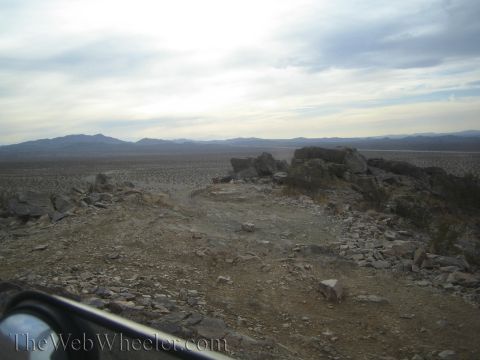 1990 Ford Bronco - Looking out over a rocky ridge crest across an expansive desert valley toward distant mountain ranges.