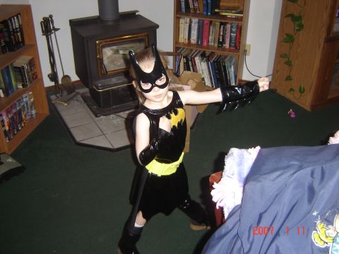 1993 Ford Bronco - A child in a Batgirl costume stands in a room, posing for a photo with a watermark.