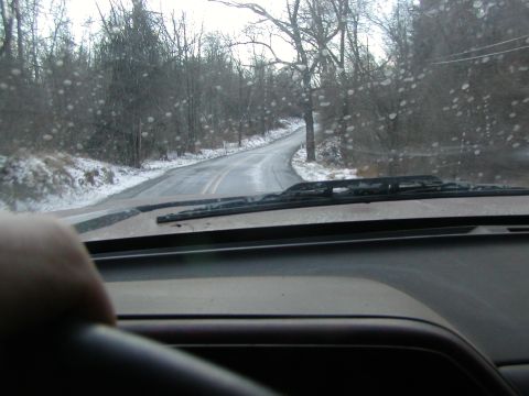 1991 Ford Bronco - Driving through a winter landscape with water droplets on the windshield.