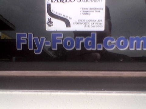1988 Ford Bronco - A window sticker displays 'Fly-Ford.com' with a smaller sticker above it.