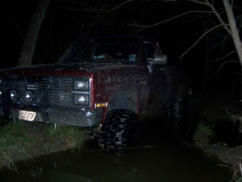 1979 Ford Bronco - Pickup truck stuck in water at night, license plate VQ2-778.