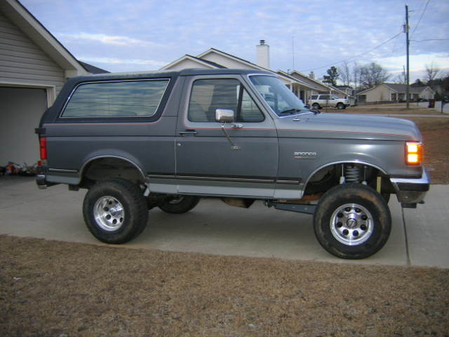 Gray lifted Ford Bronco parked in a driveway