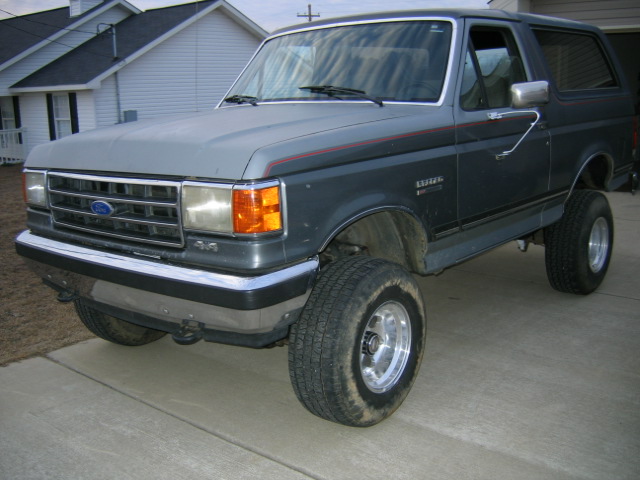 Lifted dark gray SUV with red stripe detail