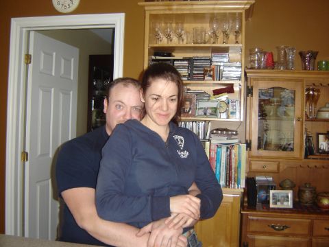 1984 Ford Bronco - A couple embraces in a home setting, with shelves filled with books and decorative items in the background.
