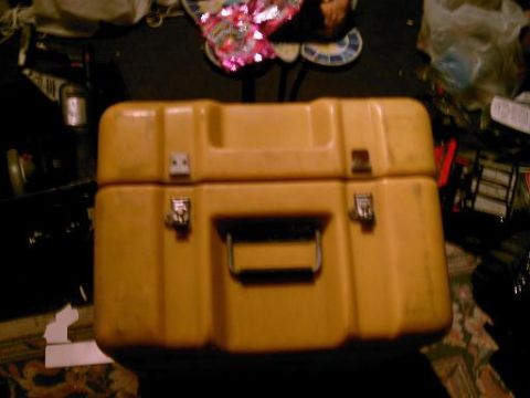 1986 Ford Bronco - A yellow plastic case with metal latches and a central handle is shown.