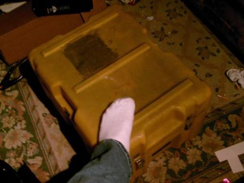 1986 Ford Bronco - A yellow plastic case sits on a patterned rug, with a foot visible in the foreground.
