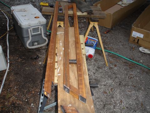 1989 Ford Bronco - Metal sliders are laid out on a workbench, with a cooler and cleaning supplies nearby.