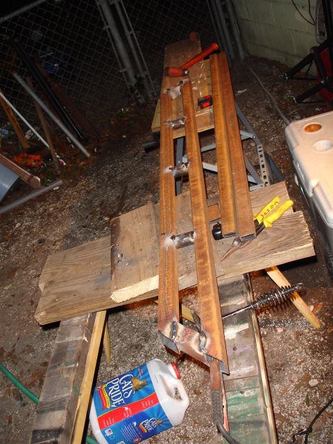 1989 Ford Bronco - Metal sliders are shown welded together and resting on wooden supports.