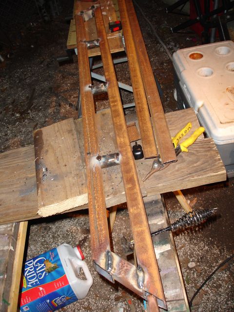 1989 Ford Bronco - Custom metal sliders are shown on a workbench, next to a jug of cat litter and tools.