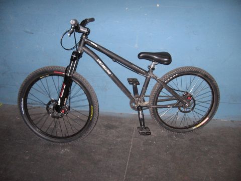 1997 Ford Probe - A black Specialized mountain bike is shown from the side against a blue wall.