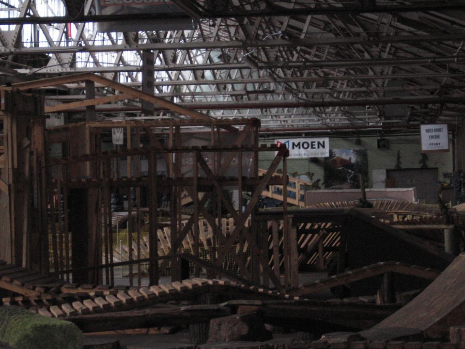 Wooden ramps and structures inside a warehouse with "MOEN" signage visible