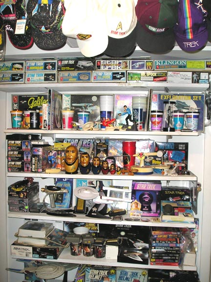 1966 Pontiac Fiero - A display shelf filled with various Star Trek collectibles, including model starships, action figures, and themed hats.