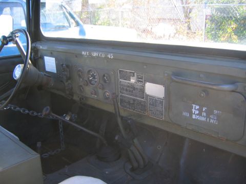2005 Ford F-250 - The interior of a military truck shows a dashboard with various gauges and warning labels, including 'MAX SPEED 45'.
