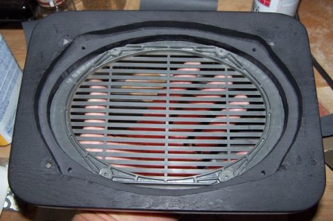 1990 Ford Bronco - A speaker adapter is shown with a hand behind its protective grille.