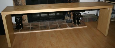 2003 Jeep TJ - A console table is positioned in front of a fireplace, flanked by decorative elephant statues.