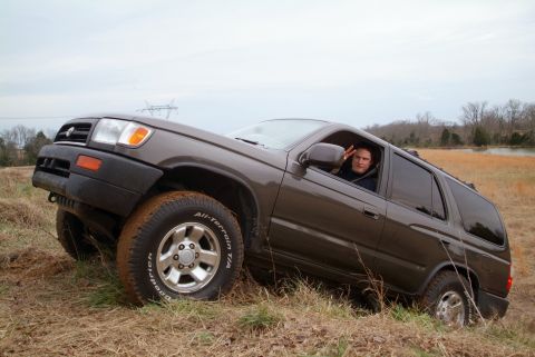 1995 Ford Bronco - A person in a Toyota 4Runner navigates uneven terrain, showing off its off-road capabilities.