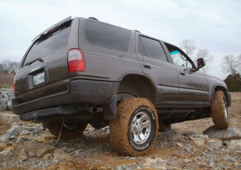 1995 Ford Bronco - This Toyota 4Runner is shown off-road with mud-covered tires and bodywork.