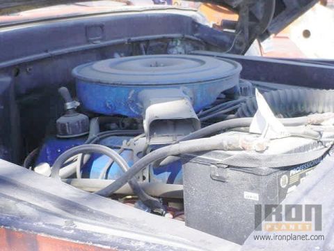 1966 Ford F-250 - Close-up view of the engine compartment of a 1966 Ford F-250, showing the air filter and battery.