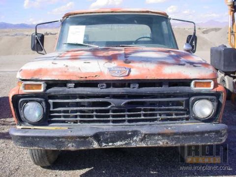1966 Ford F-250 - Front view of a 1966 Ford F-250 truck with faded orange and white paint.