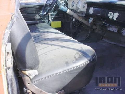 1966 Ford F-250 - The interior of a 1966 Ford F-250 truck, with a focus on the driver's seat and dashboard.