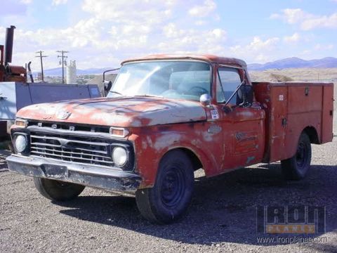 1966 Ford F-250 - This older Ford truck, likely a 1965 model, has a utility bed and shows significant signs of age and use.