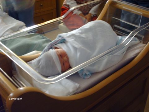 1995 Ford Probe - A newborn baby rests in a hospital bassinet, dated 04/10/2021.