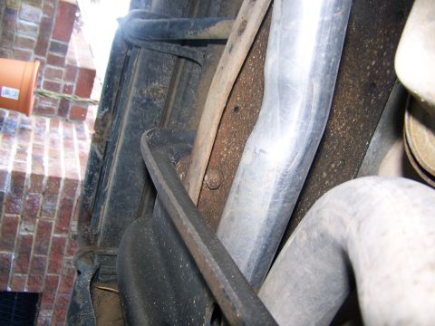 1996 Ford Bronco - Close-up view of the exhaust system and undercarriage components, with visible text from Supermotors.net.