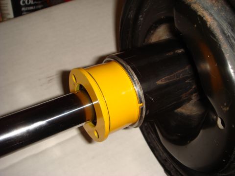 1993 Ford Taurus - A yellow suspension bushing is shown installed on a black rod, likely part of a vehicle's suspension system.