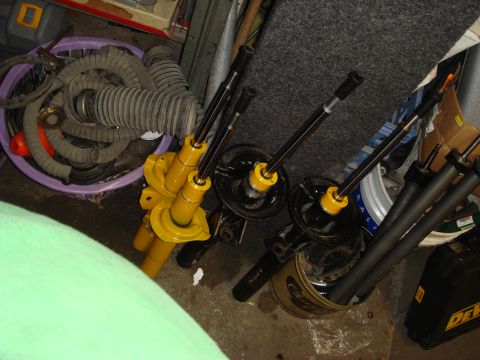 1993 Ford Taurus - Car parts are organized on a shelf, with a yellow jack stand visible.