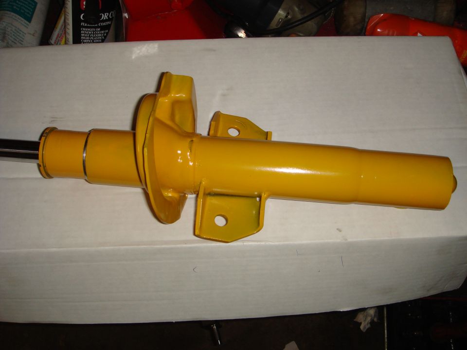 yellow dipstick handle on a white surface