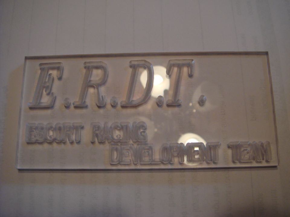 Embossed sign reading E.R.D.T. ESCORT RACING DEVELOPMENT TEAM