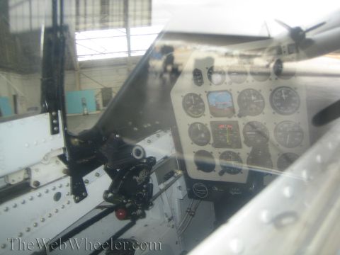 1990 Ford Bronco - close view through a canopy shows a dense aircraft instrument panel of round gauges and a control stick.