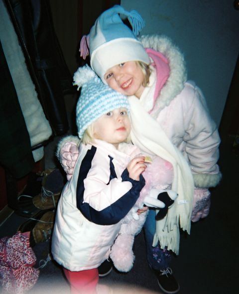 2002 Oldsmobile Aurora - Two young girls dressed for cold weather pose for a photo indoors.