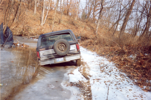 1982 Ford Bronco - This 1980s Ford Bronco appears stuck in icy water on a snowy, wooded trail.