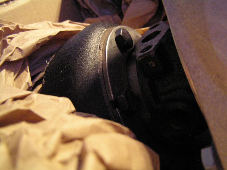 Cast iron turbocharger housing packed in a cardboard box with kraft paper